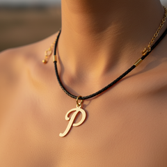 Modelo usando collar de inicial P en oro laminado con cordón de cuero negro